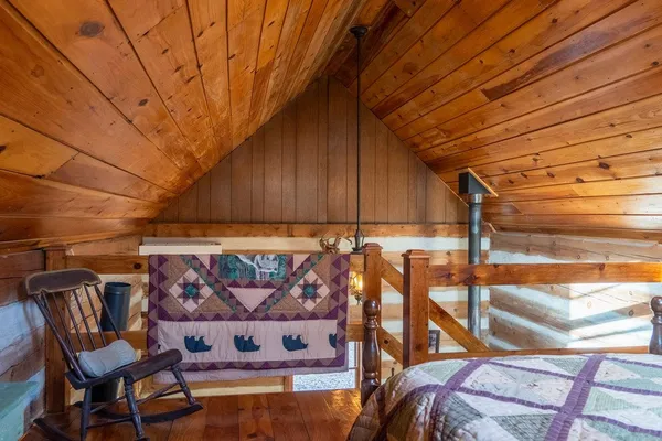 a front view of a house with garden and trees