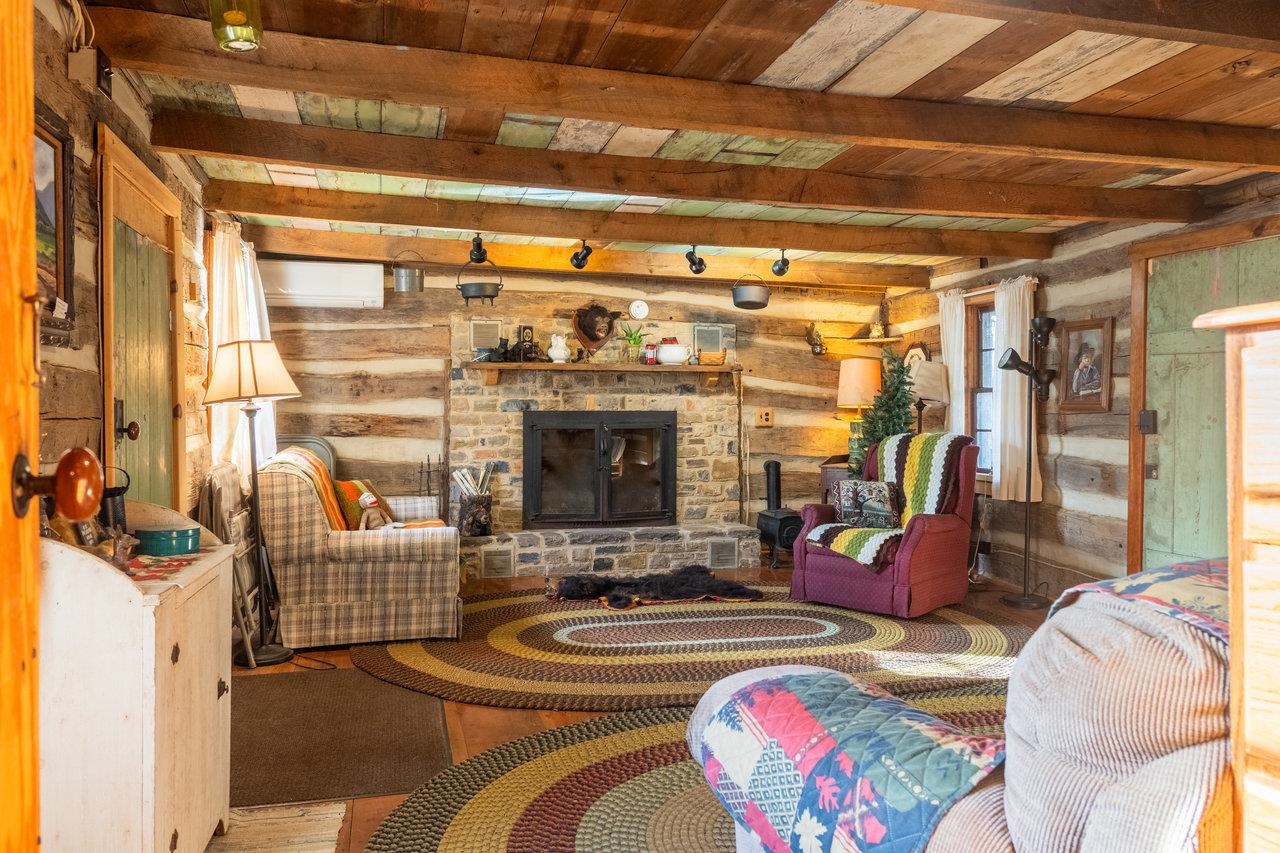 800 Cove Mountain Road Mathias, WV 26812 - Photo 29 of 74 a living room with patio fireplace furniture and a floor to ceiling window