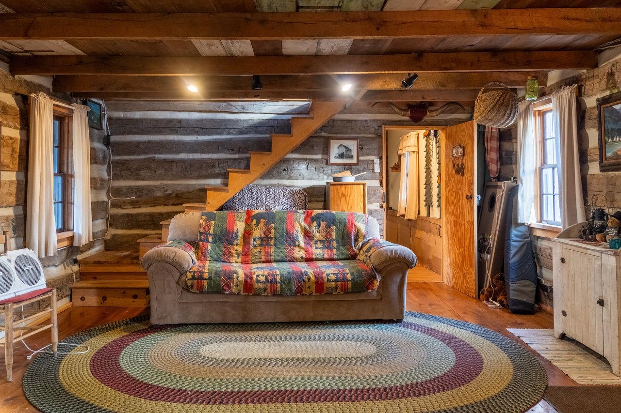 800 Cove Mountain Road Mathias, WV 26812 - Photo 37 of 74 a living room with furniture and a floor to ceiling window