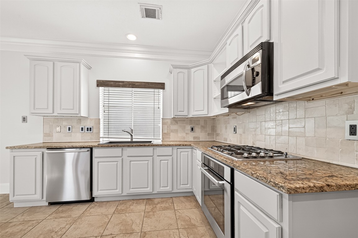 23206 Kobi Park Court Spring, TX 77373 - Photo 15 of 46 Kitchen boasts stainless steel appliances and ample cabinet storage.