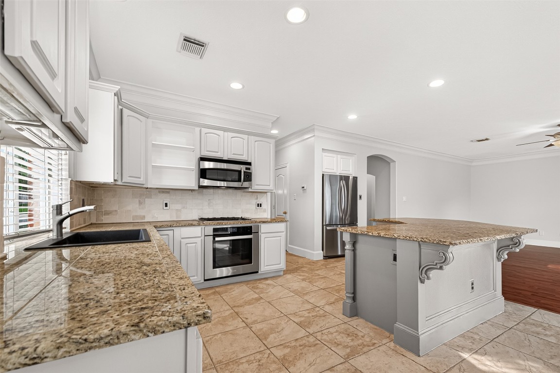 23206 Kobi Park Court Spring, TX 77373 - Photo 16 of 46 Notice the sizable island and bar seating.