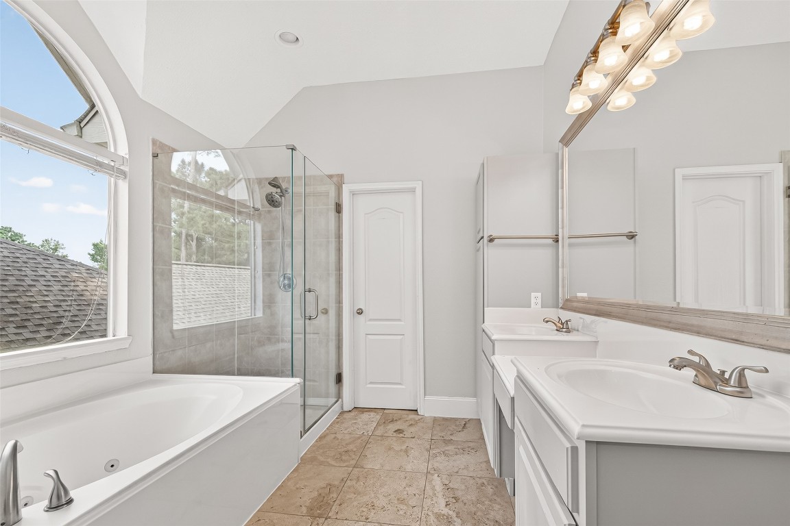 23206 Kobi Park Court Spring, TX 77373 - Photo 28 of 46 Primary bath boasting double sinks, jetted tub, and walk-in shower.