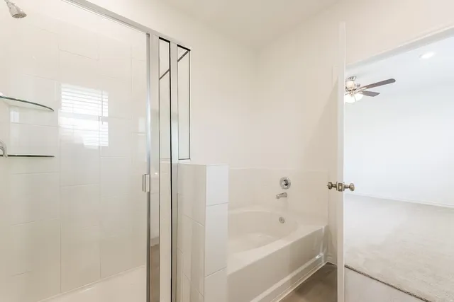 a bathroom with a bathtub and shower
