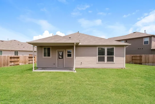 a front view of a house with a garden and yard
