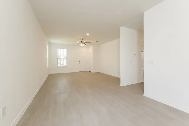 an empty room with windows and closet