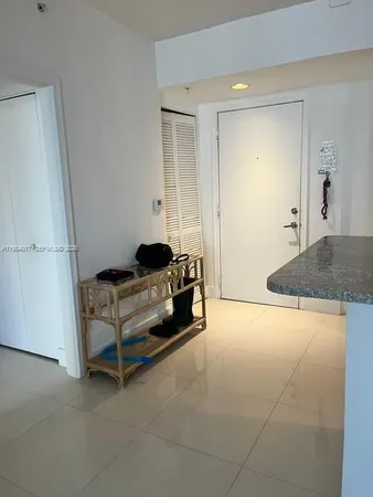 a spacious bedroom with a bed and a cabinets