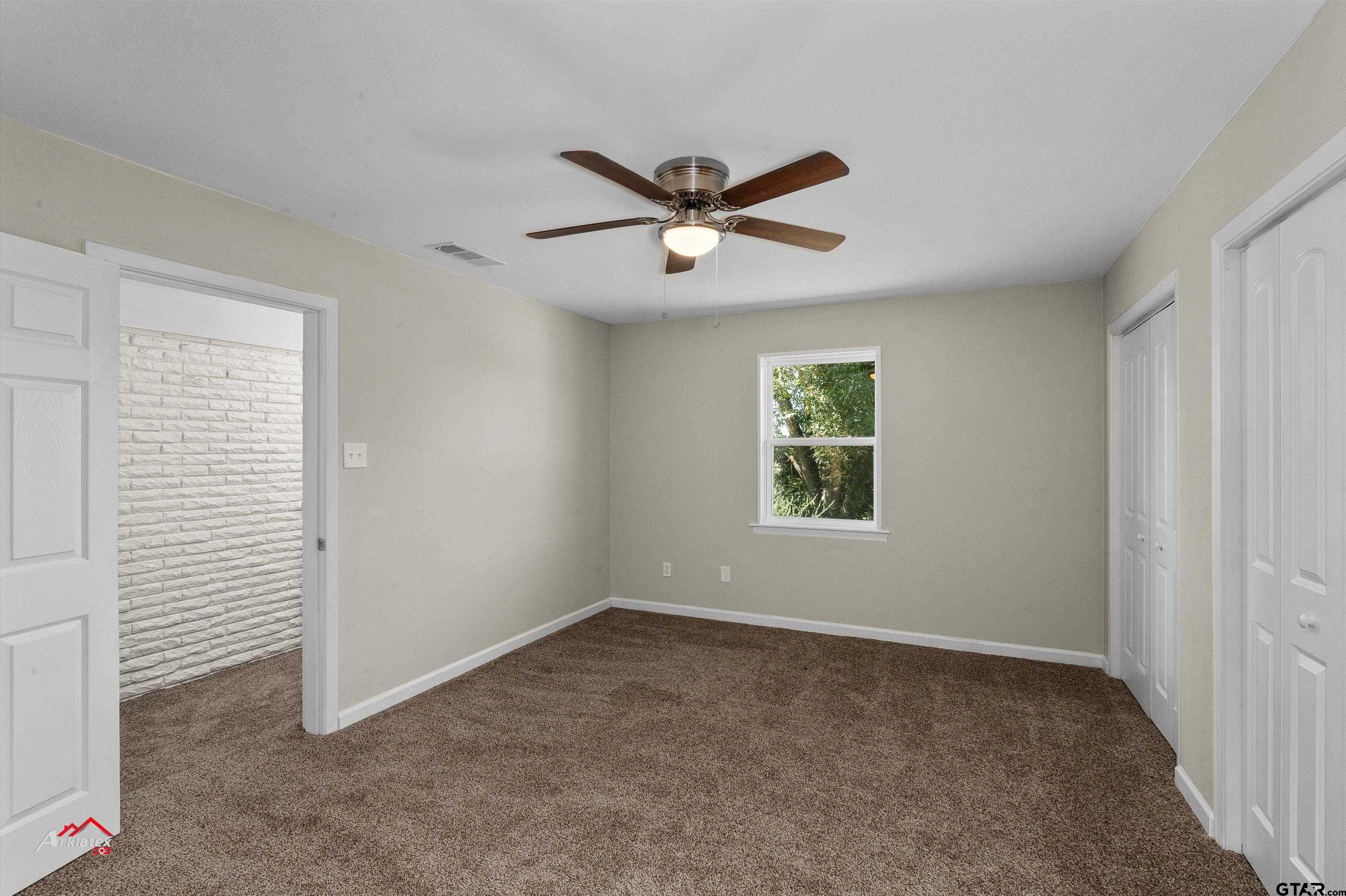 6973 FM 449 Marshall, TX 75670 - Photo 14 of 29 a view of a livingroom with a ceiling fan & window