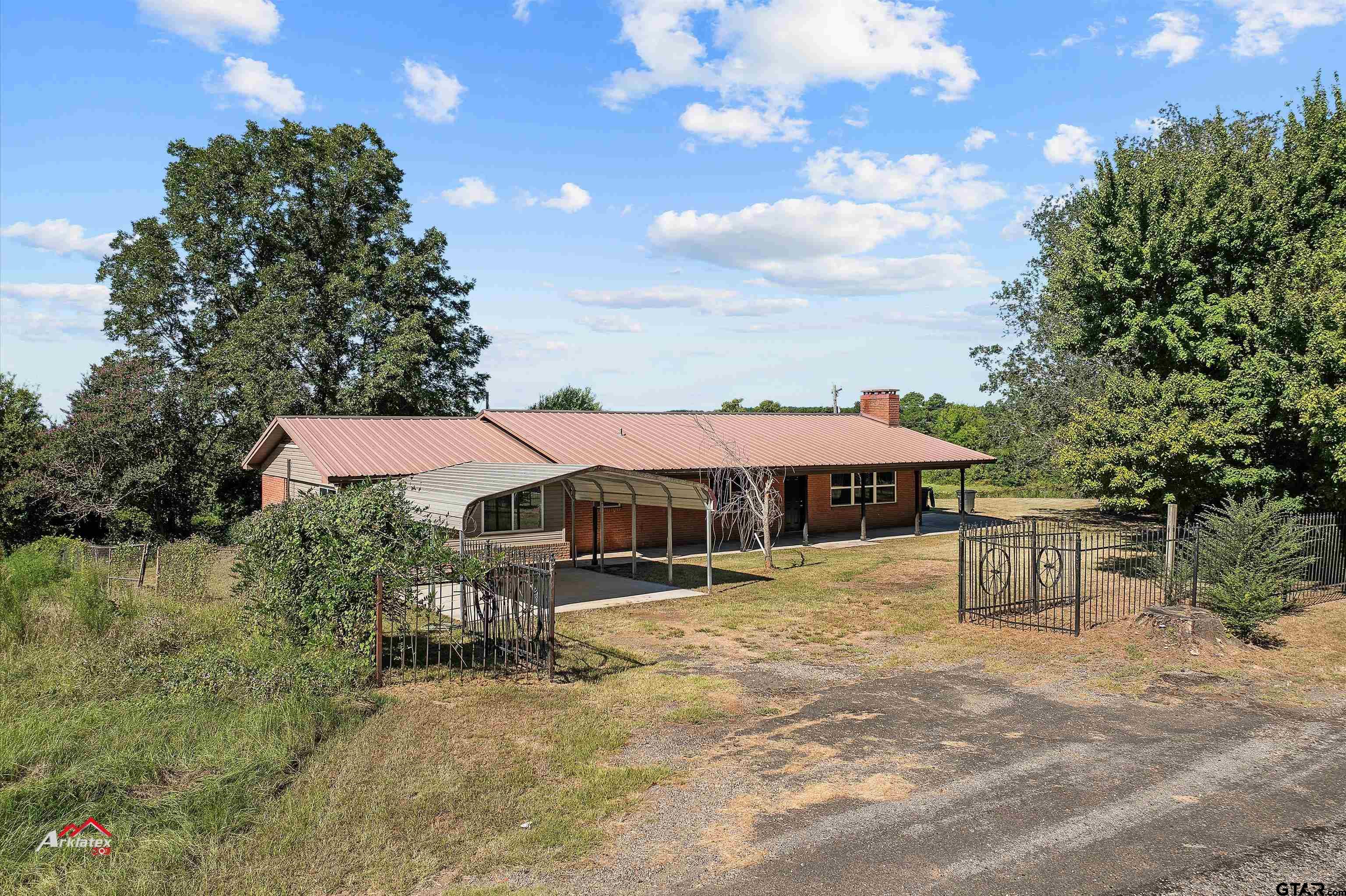 6973 FM 449 Marshall, TX 75670 - Photo 16 of 29 a view of a house with a yard