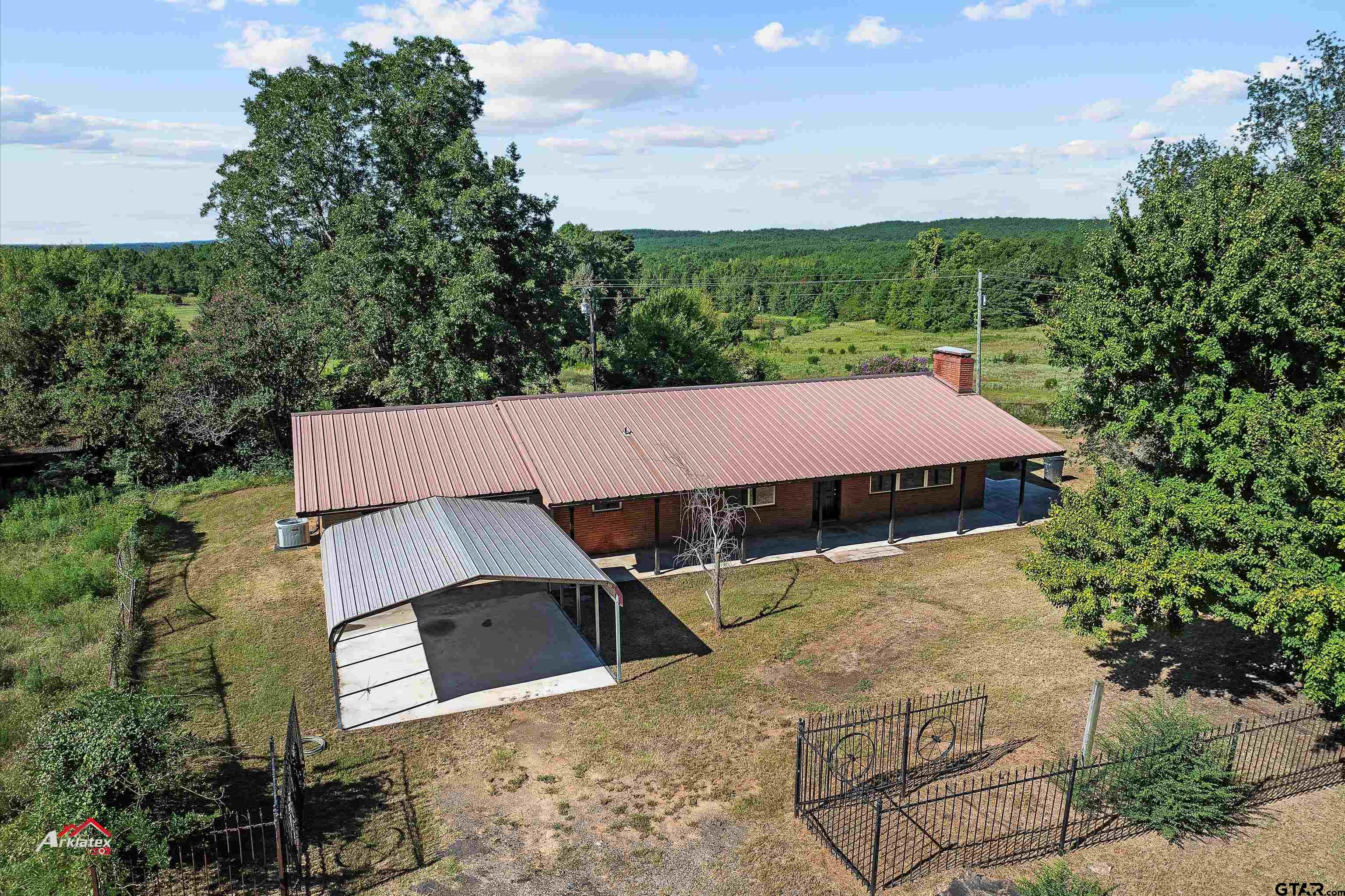 6973 FM 449 Marshall, TX 75670 - Photo 17 of 29 an aerial view of a house with yard and outdoor seating
