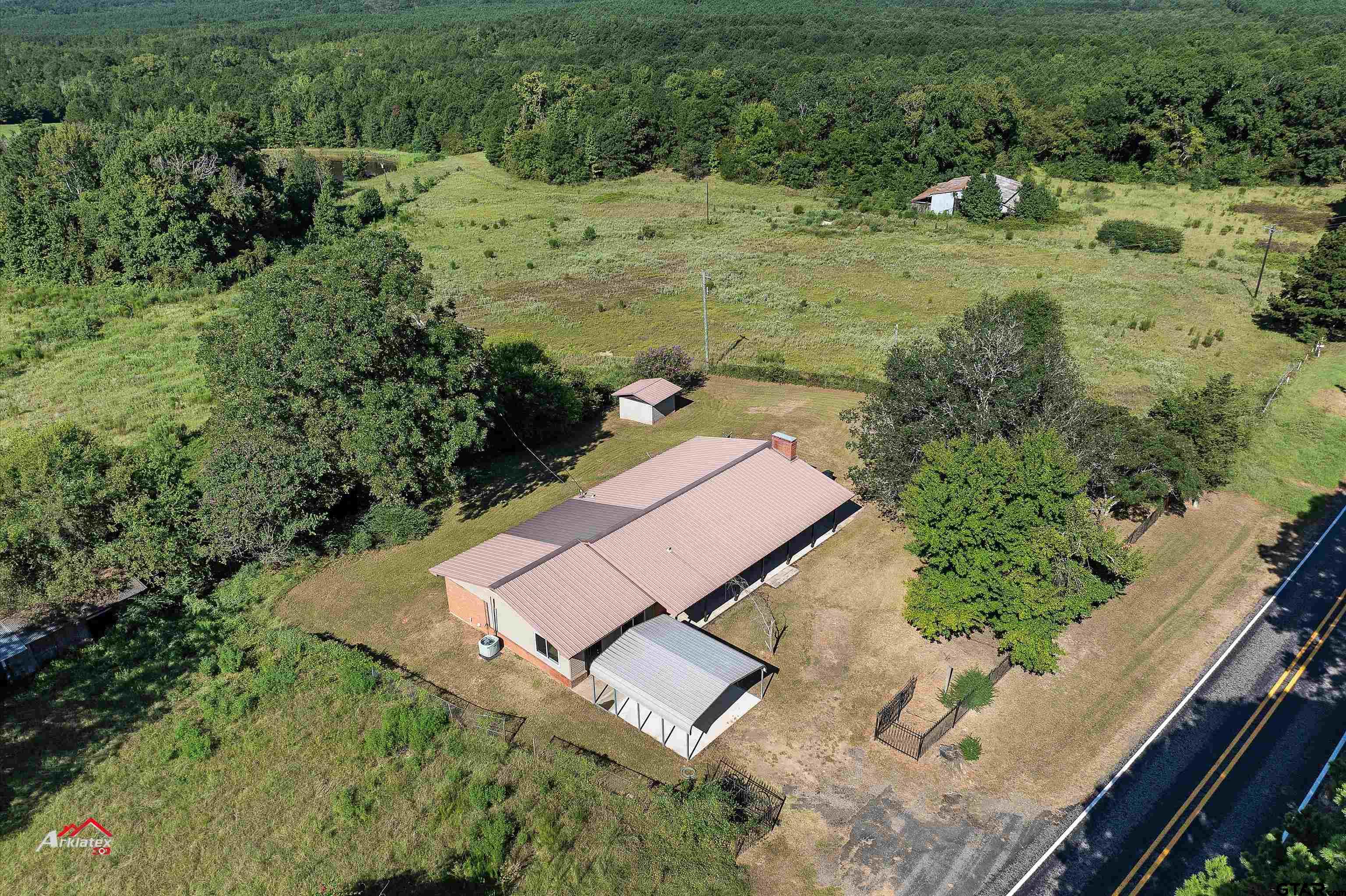 6973 FM 449 Marshall, TX 75670 - Photo 18 of 29 an aerial view of a house with a yard