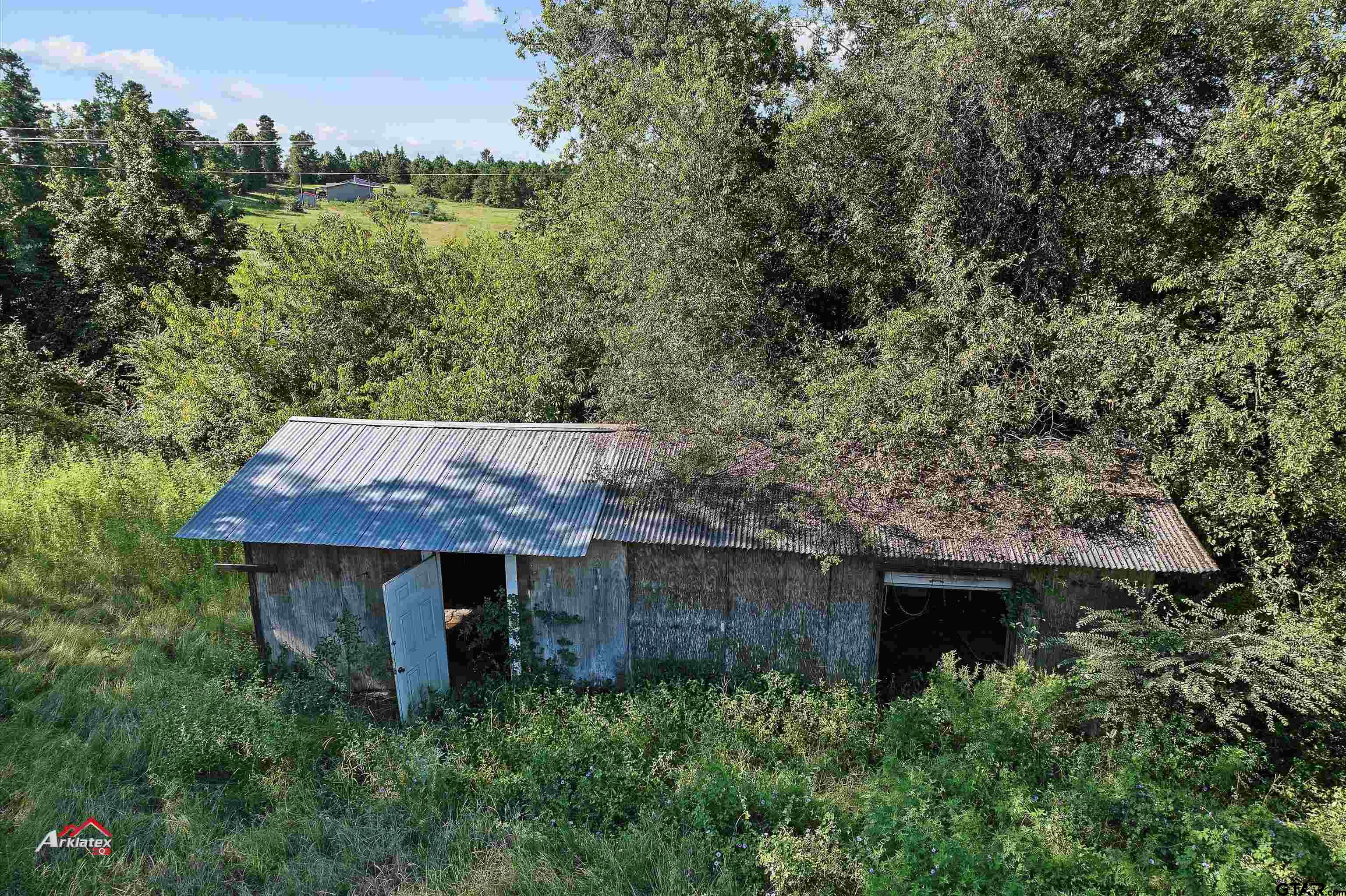 6973 FM 449 Marshall, TX 75670 - Photo 27 of 29 an view of barn with large trees