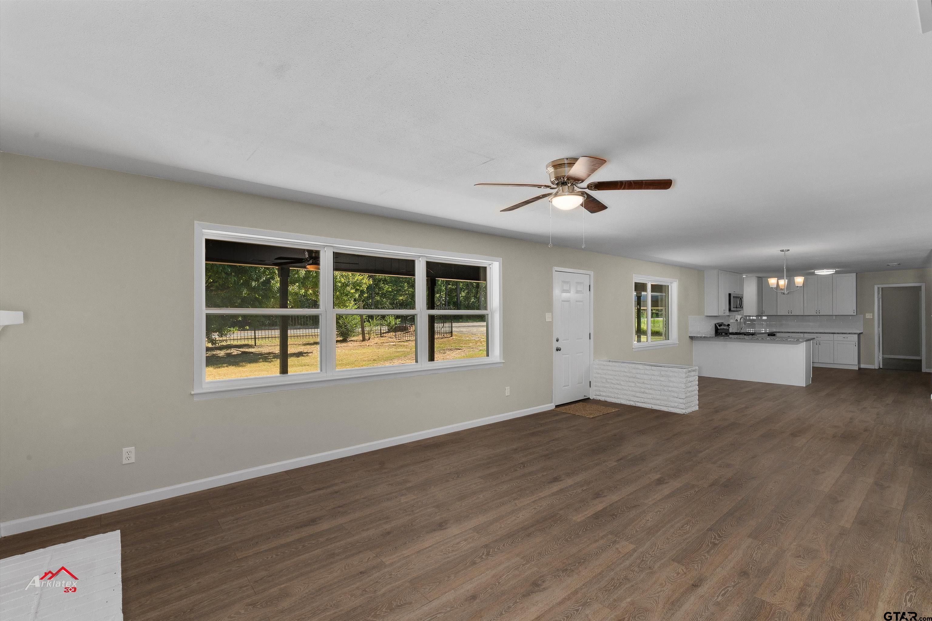 6973 FM 449 Marshall, TX 75670 - Photo 4 of 29 a view of empty room with wooden floor and fan