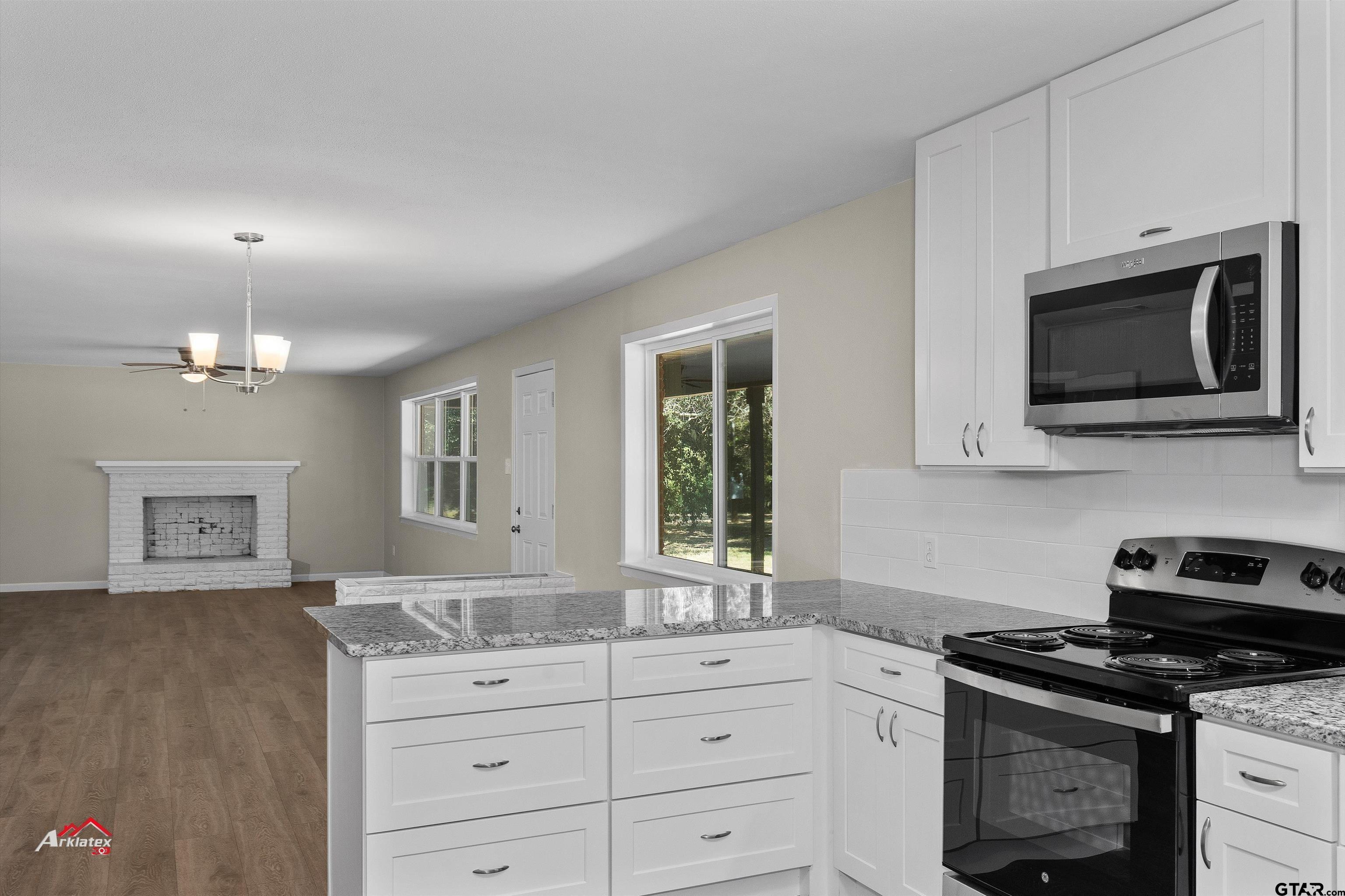 6973 FM 449 Marshall, TX 75670 - Photo 7 of 29 a kitchen with stainless steel appliances granite countertop a stove a sink and a microwave