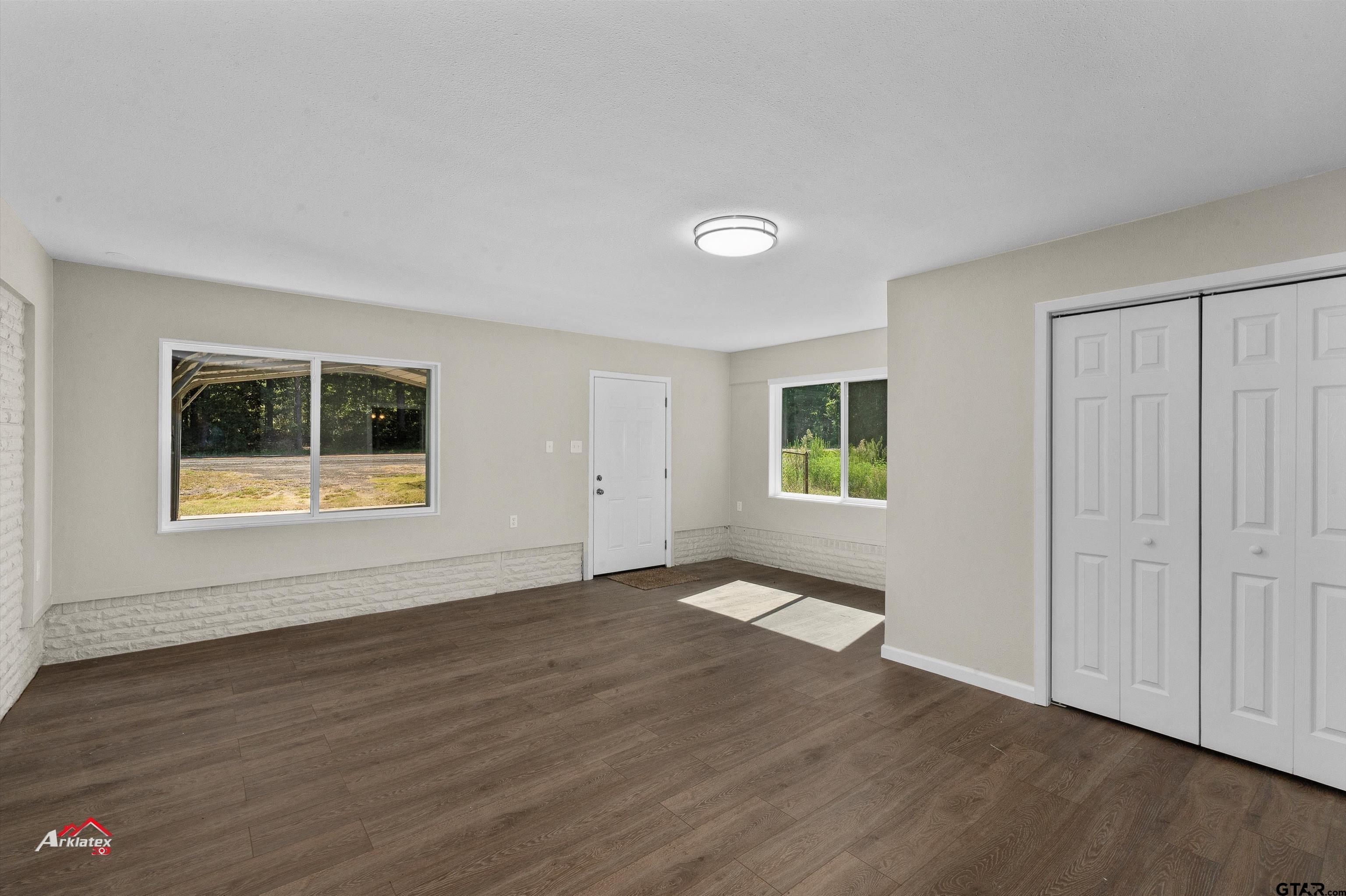 6973 FM 449 Marshall, TX 75670 - Photo 8 of 29 a view of an empty room with wooden floor and a window