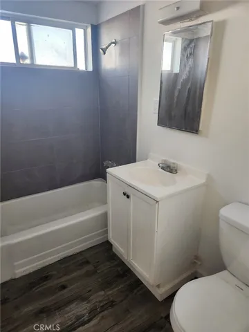 a bathroom with a toilet a sink and bathtub