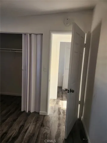 a view of a room with wooden floor and fan