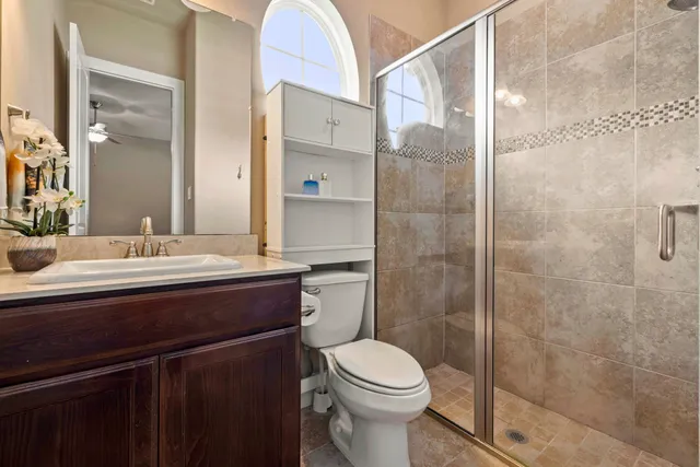 a bathroom with a sink a toilet and shower