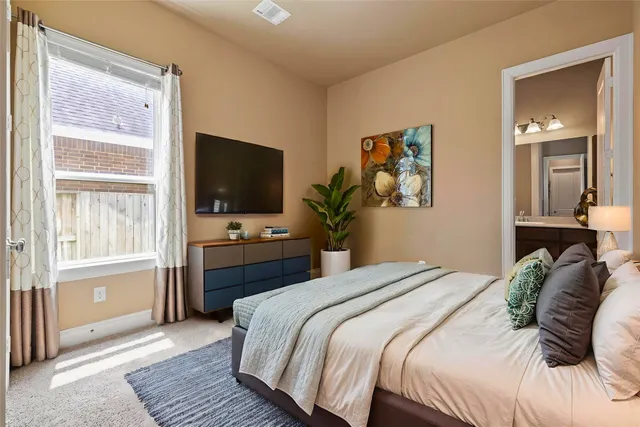 a bedroom with a bed and a television