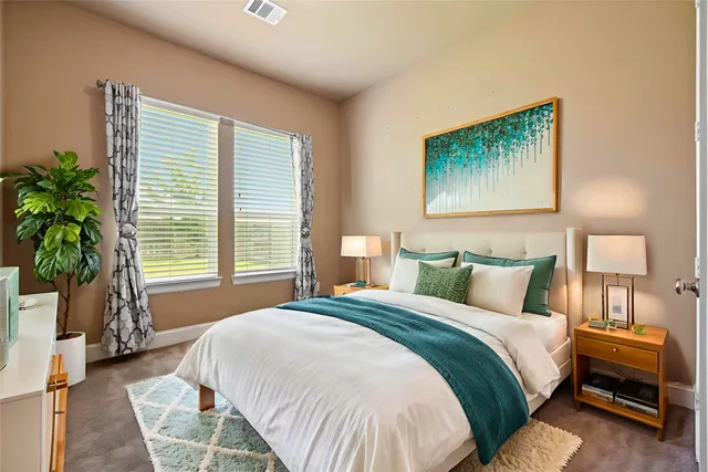 a bedroom with bed and a potted plant