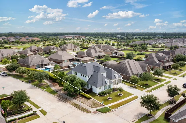 an aerial view of residential houses with outdoor space