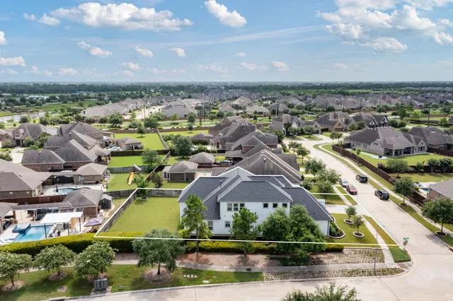 an aerial view of residential houses with lake view