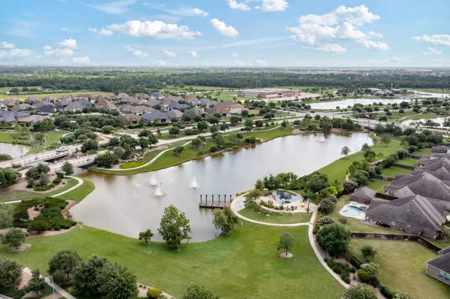 an aerial view of a residential houses with outdoor space