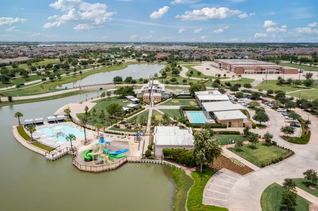 an aerial view of a house with a swimming pool patio and outdoor seating