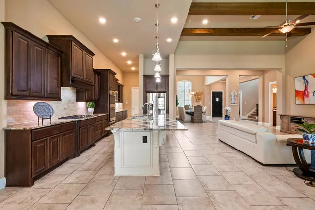 a large kitchen with stainless steel appliances lots of counter top space