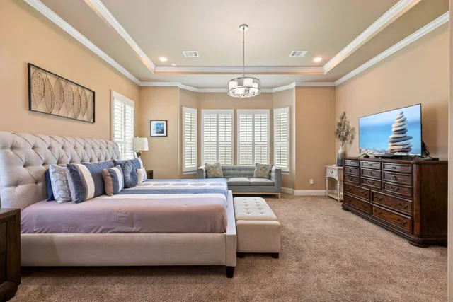 a spacious bedroom with a bed and wooden floor