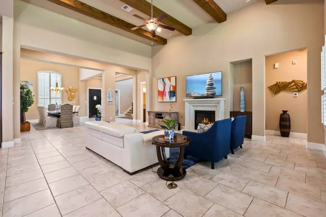 a living room with furniture a fireplace and a flat screen tv