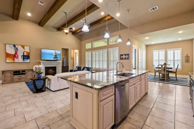 a kitchen with stainless steel appliances granite countertop a sink and a stove
