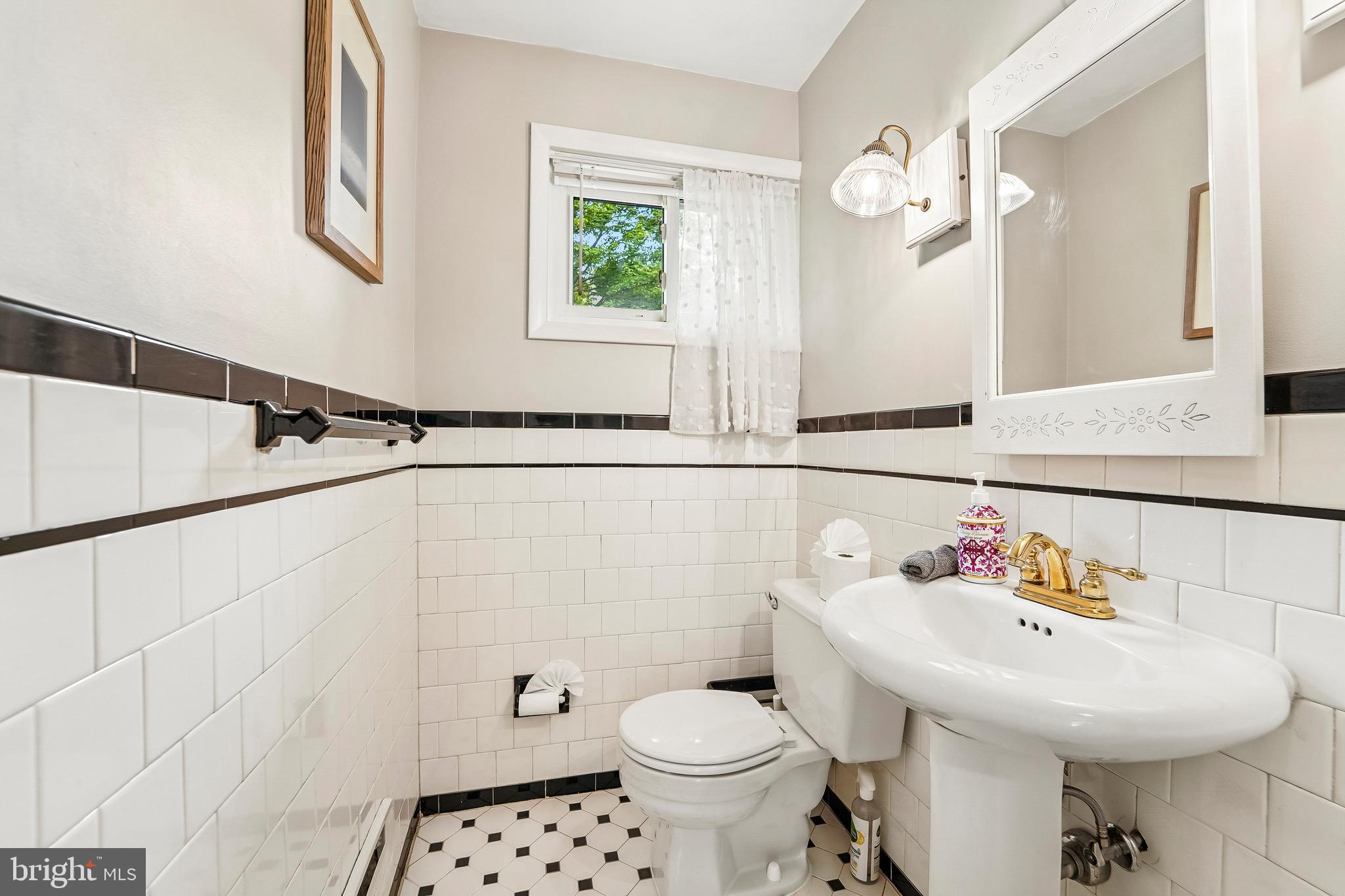 6640 Loch Hill Road Baltimore, MD 21239 - Photo 15 of 35 a bathroom with a sink toilet and a mirror