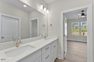 2760 River Meadow Spring Hope, NC 27882 - Photo 27 of 42 a bathroom with a sink double vanity and a mirror