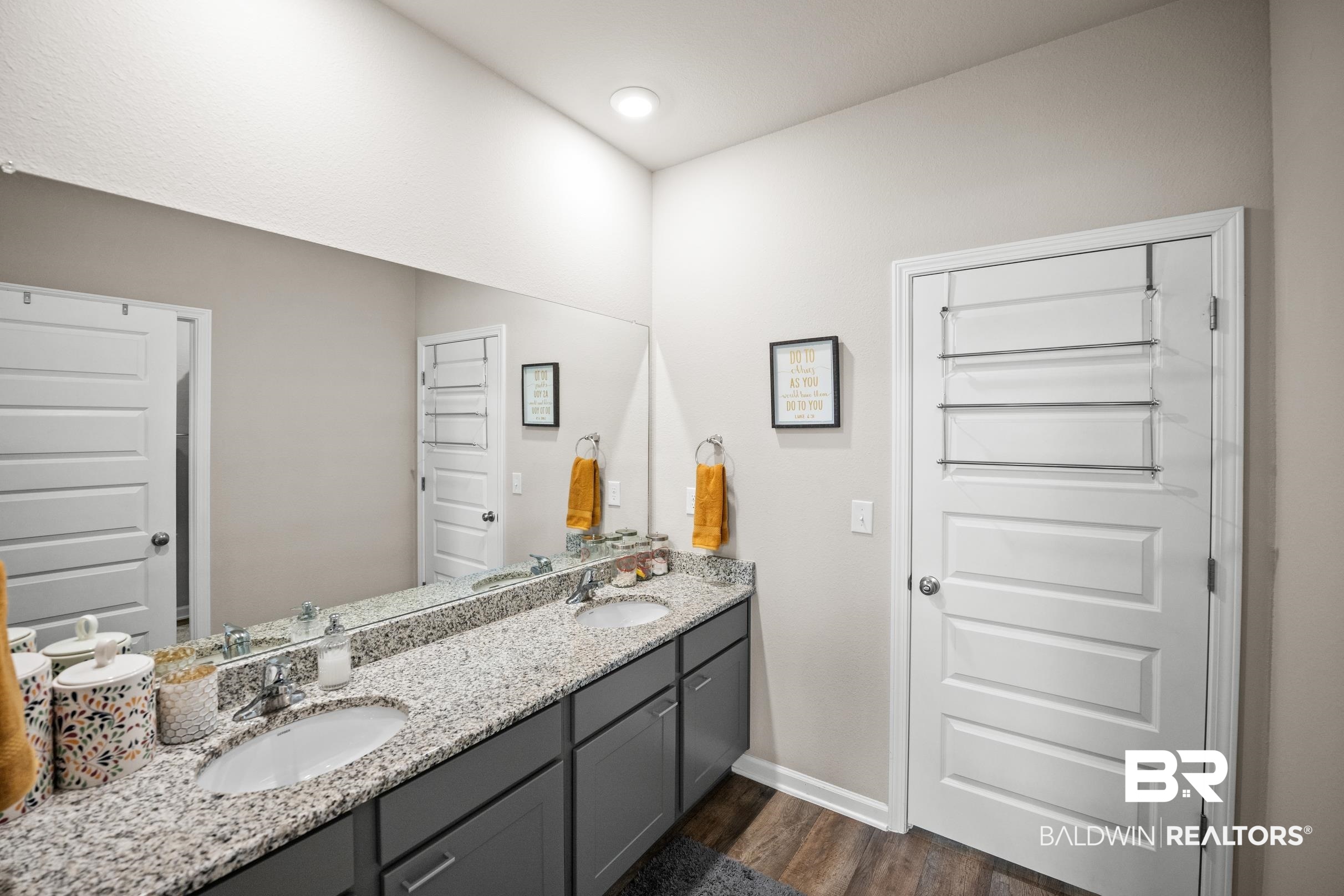 24139 Veranda Circle Elberta, AL 36530 - Photo 28 of 40 Bathroom featuring double vanity, wood finished floors, baseboards, and a sink
