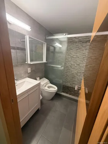a bathroom with a double vanity sink toilet and shower