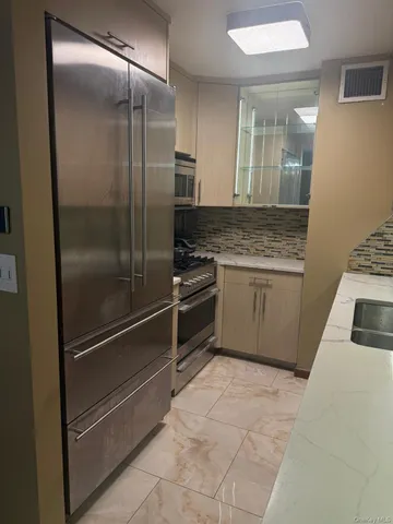 a kitchen with a refrigerator and a sink