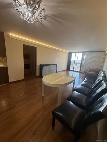 a view of a room with wooden floor