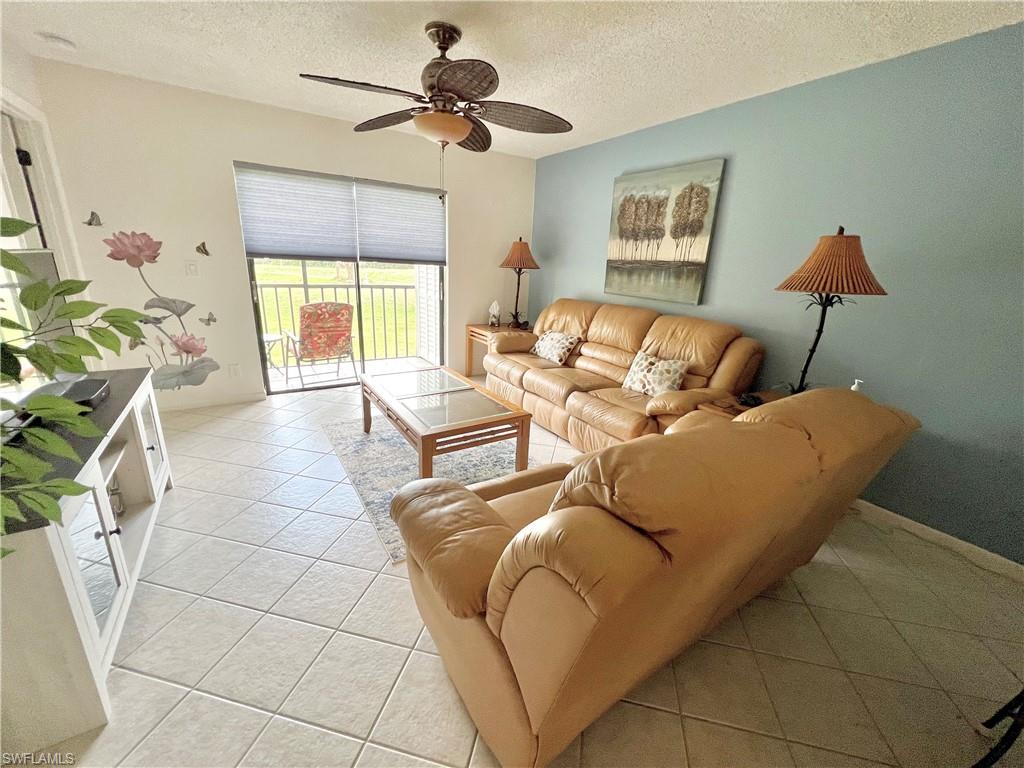 4338 27th Court Southwest, Unit 8201 Naples, FL 34116 - Photo 3 of 16 a living room with furniture and a window