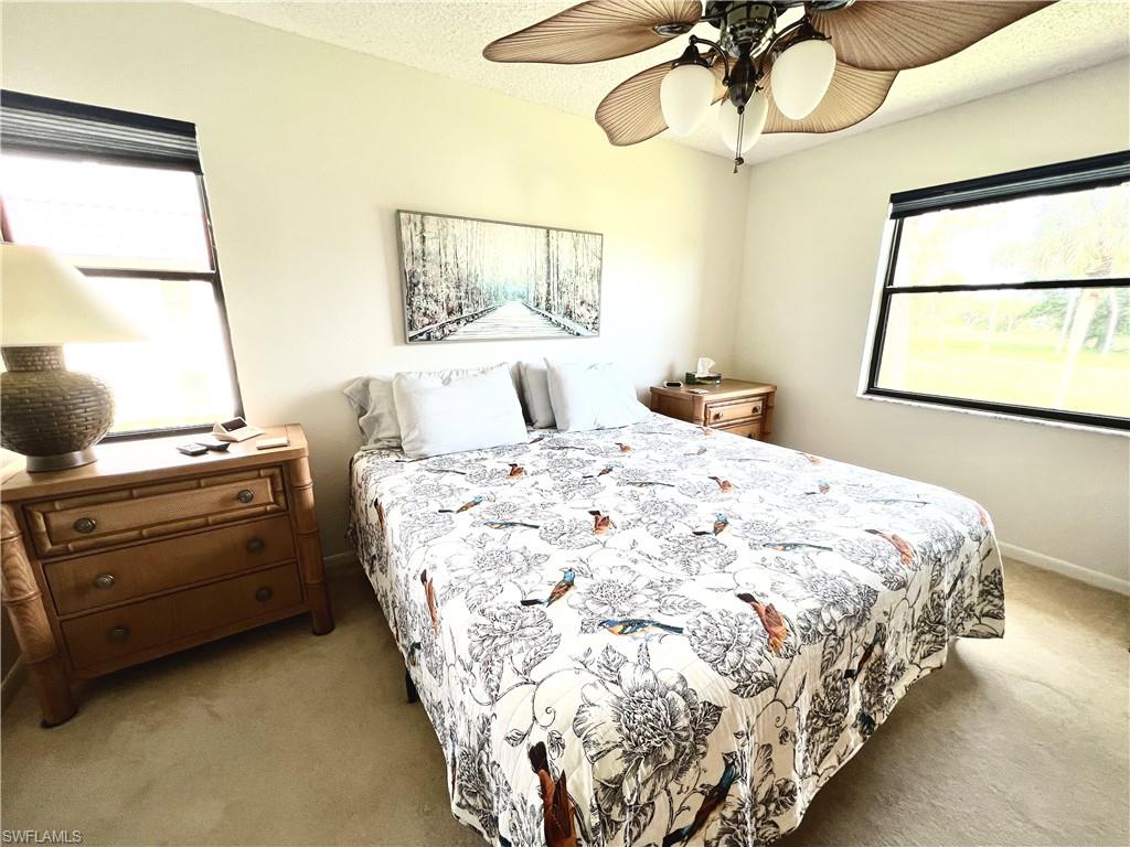 4338 27th Court Southwest, Unit 8201 Naples, FL 34116 - Photo 5 of 16 a bedroom with a bed and a window