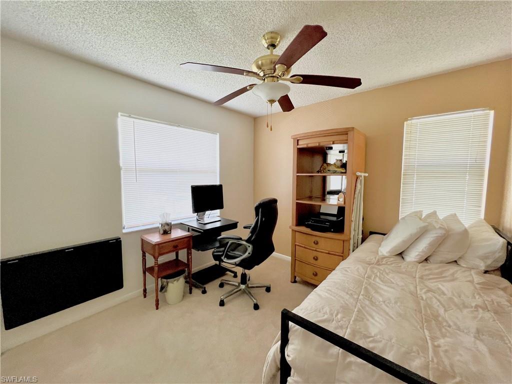 4338 27th Court Southwest, Unit 8201 Naples, FL 34116 - Photo 7 of 16 a bedroom with a bed and a desk