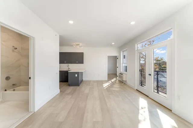 a view of a hallway with a kitchen
