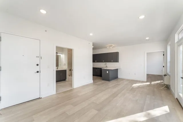 a view of a kitchen with a sink and a refrigerator