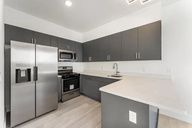 a kitchen with a refrigerator and a sink