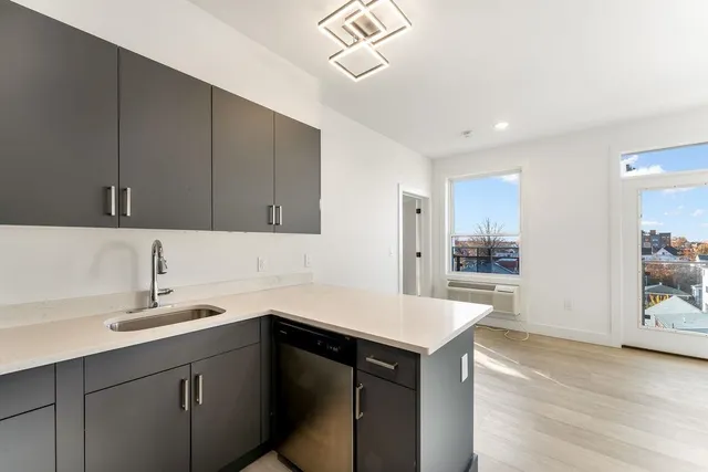 a kitchen with a sink cabinets and appliances