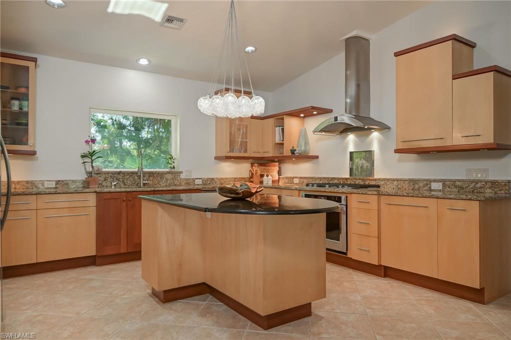 6350 Parkers Hammock Road Naples, FL 34112 - Photo 10 of 49 a kitchen with stainless steel appliances granite countertop a sink stove and refrigerator