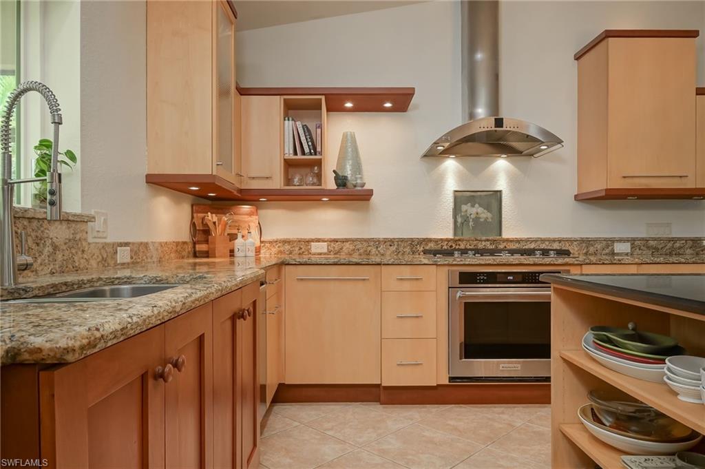 6350 Parkers Hammock Road Naples, FL 34112 - Photo 11 of 49 a kitchen with granite countertop stainless steel appliances a sink and cabinets