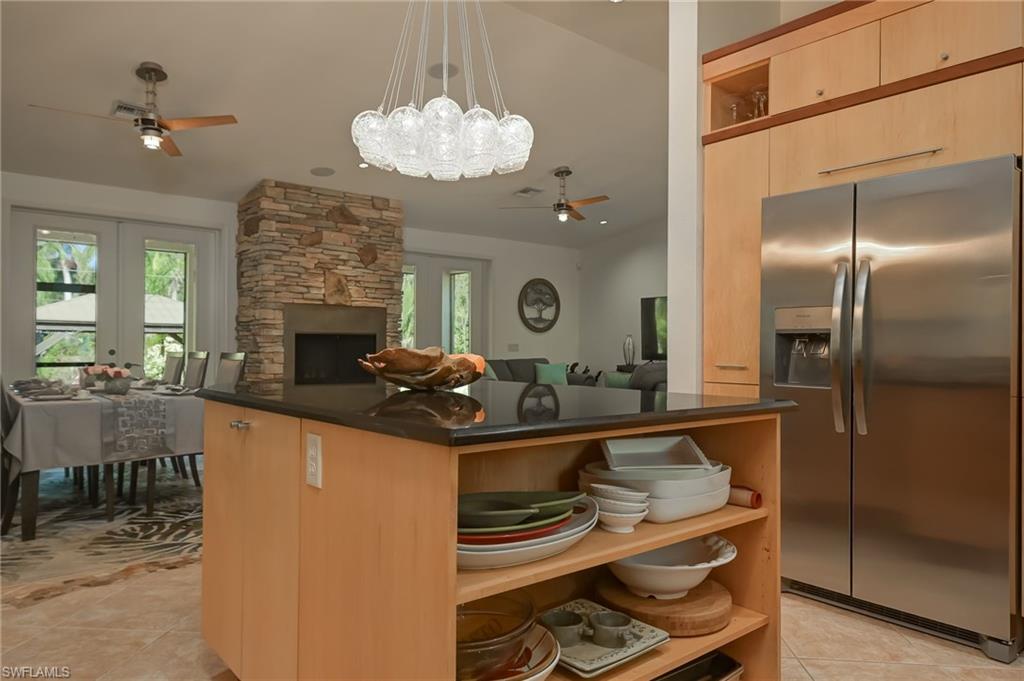 6350 Parkers Hammock Road Naples, FL 34112 - Photo 12 of 49 a kitchen with kitchen island stainless steel appliances a sink stove and refrigerator