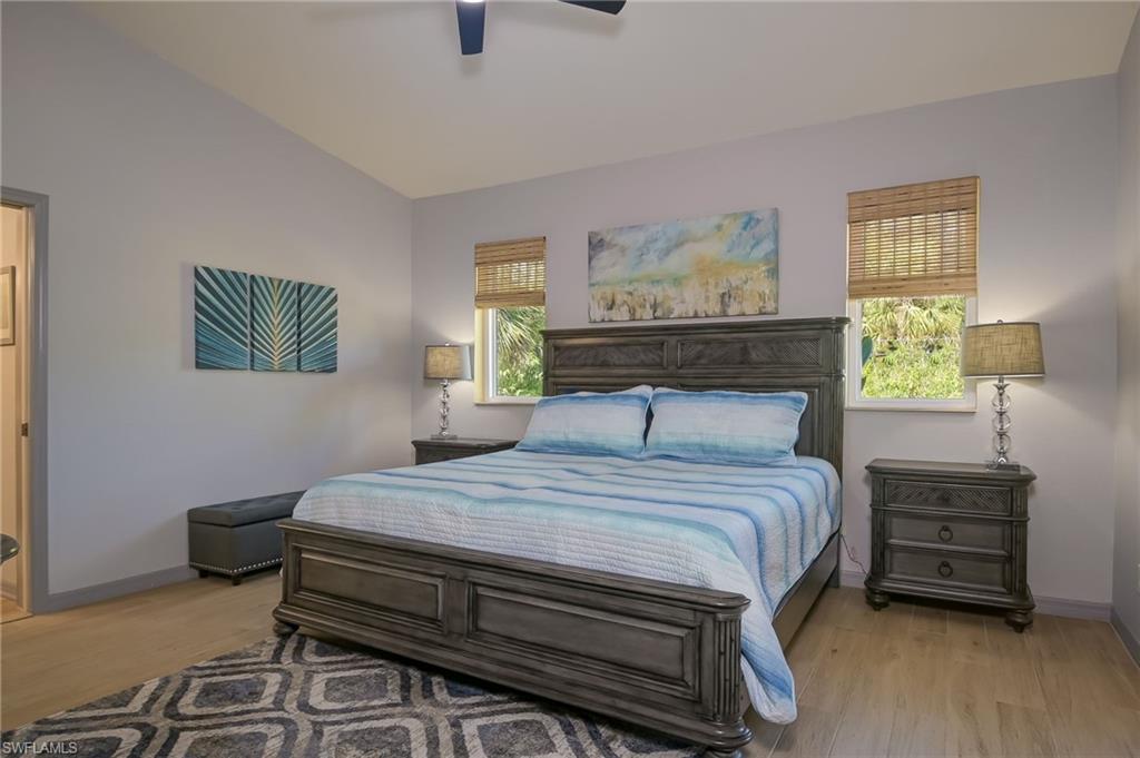 6350 Parkers Hammock Road Naples, FL 34112 - Photo 16 of 49 a bedroom with a bed and a lamp on dresser