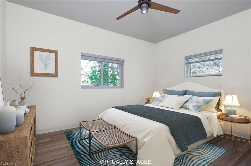 6350 Parkers Hammock Road Naples, FL 34112 - Photo 23 of 49 a bedroom with a bed and wooden floor