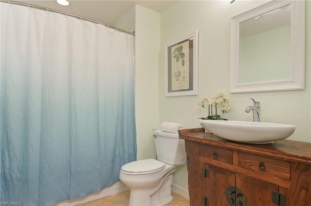 6350 Parkers Hammock Road Naples, FL 34112 - Photo 25 of 49 a bathroom with a sink toilet and a mirror